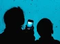 Woman and child with smartphone in hand looking at aquarium