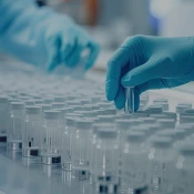 "Blue gloved hands working with test tubes"