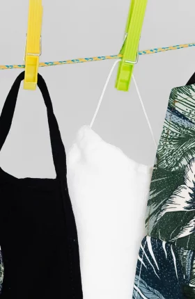 Close-up of face masks hanging with clothespins on a line