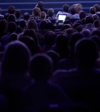 Silhouette of an audience at a conference