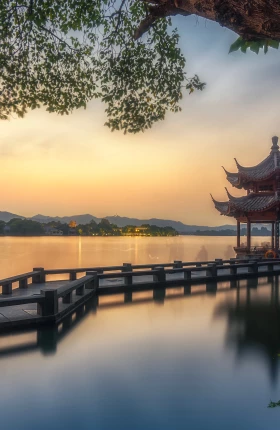 View of a pagoda overlooking the water at sunset