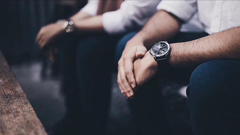 Close up image of two people wearing watches