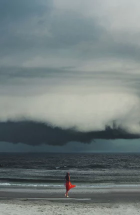 Person standing and watching a hurricane cloud