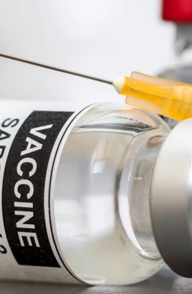 Close up view of the covid-19 vaccine bottle and needle