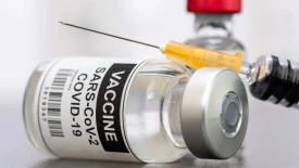 Close up view of the covid-19 vaccine bottle and needle