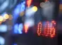 Close-up, blurred shot of blue, red, and yellow-lit numbers on a digital screen