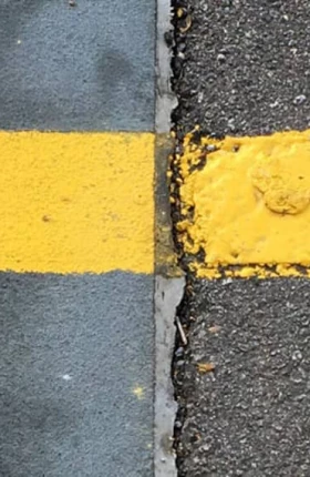 Yellow line of paint on the ground