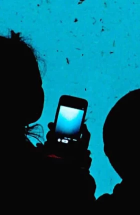 Woman and child with smartphone in hand looking at aquarium