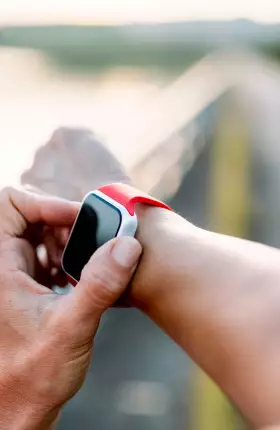 Person starting a stopwatch on their wrist