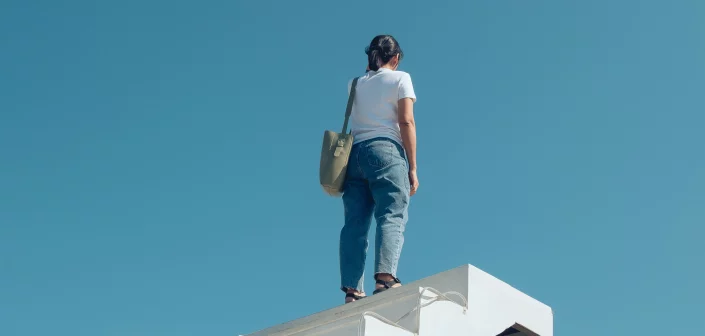 Person standing atop white staircase that goes nowhere