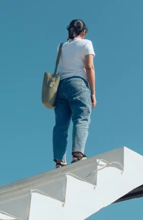 Person standing atop white staircase that goes nowhere