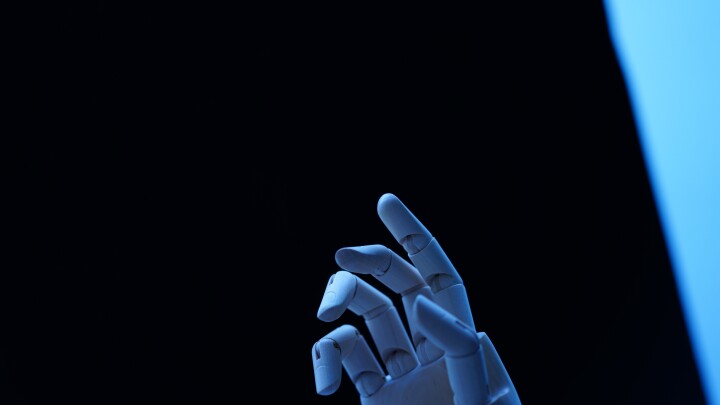 CLOSE-UP OF HUMAN HAND AGAINST BLACK BACKGROUND
