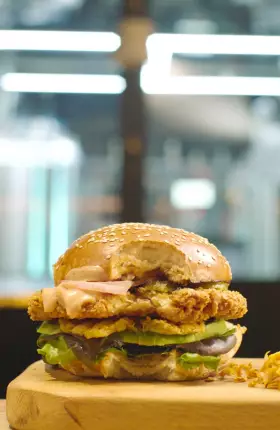 Close-up of a chicken sandwich and French fries on a plate