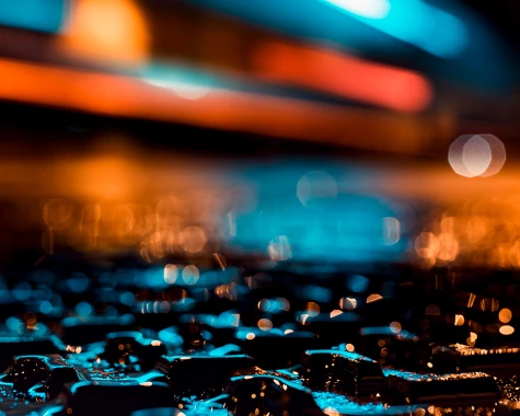 Wet ground illuminated by blue and orange light at night