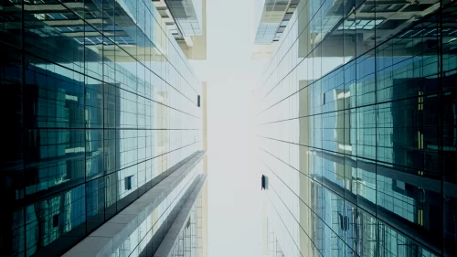 Sliver of sky between two glass buildings