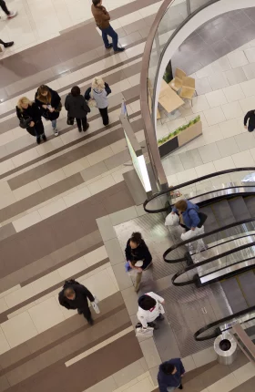 Aerial view of people going up escalators