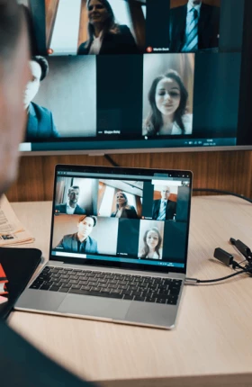 Businessman discussing with colleagues on video call