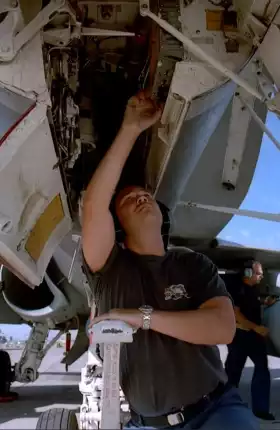 Man working on plane engine