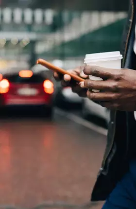 Person using their phone while crossing the street