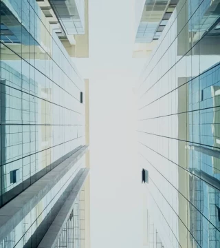 Sliver of sky between two glass buildings