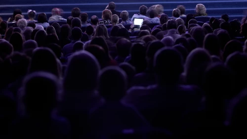 Silhouette of an audience at a conference