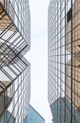 View of two orange glass buildings from below