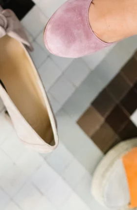 Variety of women's shoes sitting on a tile floor