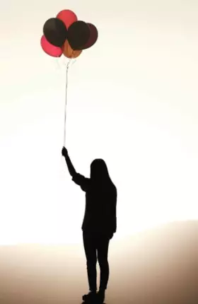 Woman holding balloons